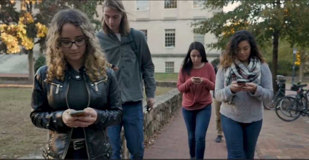 College students Hows the extreme addiction to smartphone via campus students scrolling while walking, not looking up